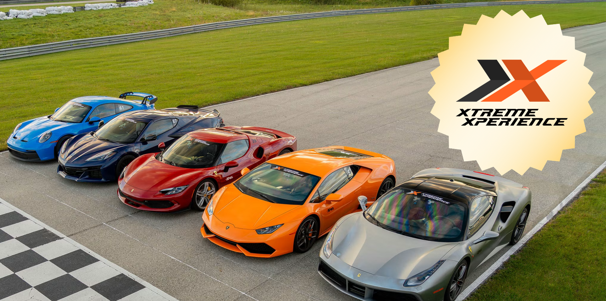 Aerial view of a lineup of colorful sports cars on a race track (blue, dark blue, red, orange, silver), with a large XTREME XPERIENCE badge in the upper right corner.
